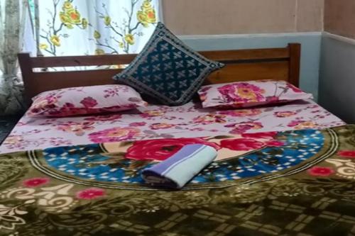a bed with a plate on top of it at Rongo Shreya Homestay by StayApart in Kumai
