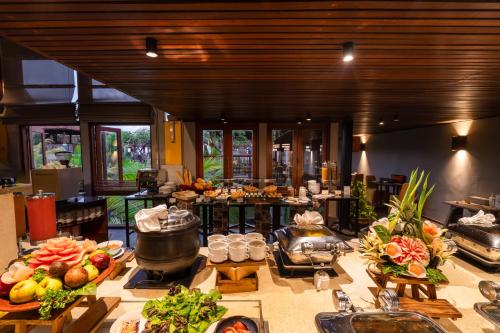 a kitchen with a table with fruits and vegetables on it at Mercure Kuta Bali in Kuta