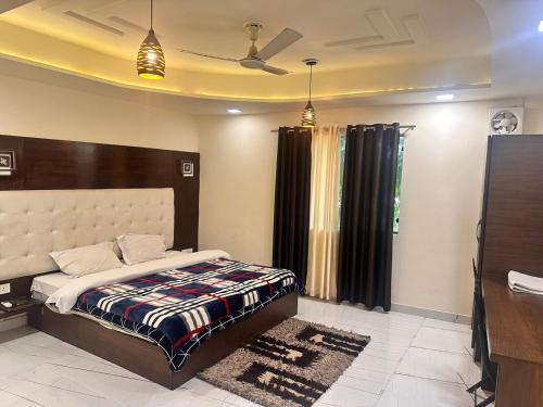 a bedroom with a bed and a television in it at Taj Castle Homestay sutable for 17 Peoples in Agra