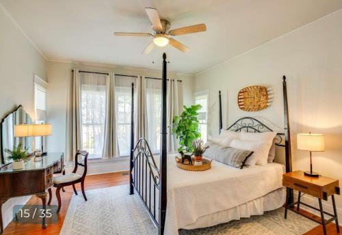 a bedroom with a bed with a ceiling fan and a desk at Pack N Play Walk to Downtown Pet Friendly in Canton