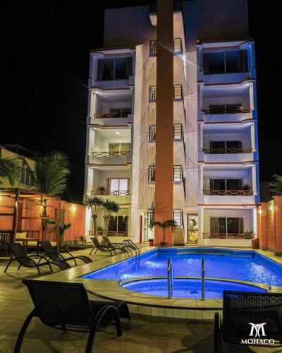 a swimming pool in front of a building at night at Monaco Chicama Beach in Puerto Chicama