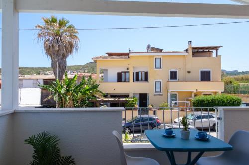 a balcony with a table and a view of a building at Eos affittacamere in Castelsardo
