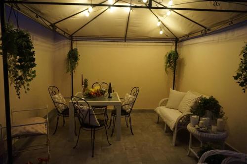 a living room with a table and chairs and a couch at Viareggio, Sweet home in Viareggio