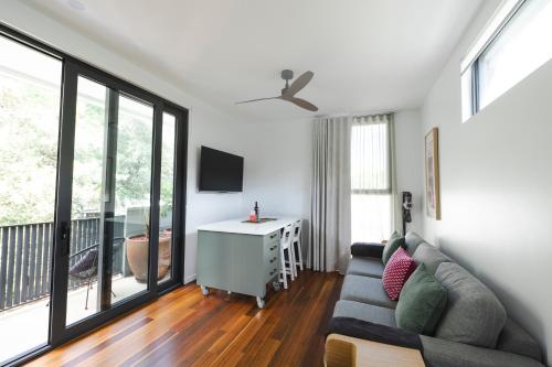 a living room with a couch and a table at Bushland setting close to Sydney CBD- stand alone apartment in Sydney