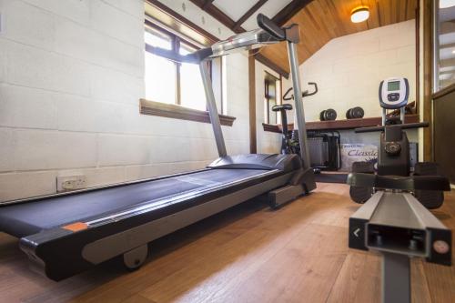 a gym with a treadmill in a room at Nuthatch near Huntsham in Tiverton