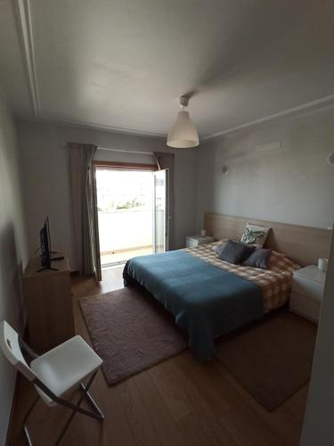 a bedroom with a large bed and a window at Merci Beach House in Carvoeira