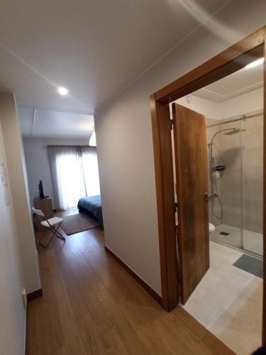 a bathroom with a shower and a sliding door at Merci Beach House in Carvoeira