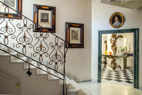 a staircase in a home with pictures on the wall at Arcom Palace in Pomezia