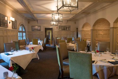 a restaurant with tables and chairs and a chandelier at Wentworth Mansion in Charleston