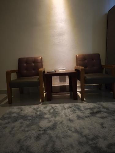 two chairs and a coffee table in a room at Long Homestay Xuyên Á - Hotels in Ðức Hòa