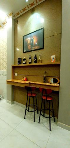 a table with two stools and a sink in a room at Long Homestay Xuyên Á - Hotels in Ðức Hòa