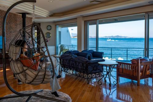 a room with a living room with a swing at Gardenia in Aji