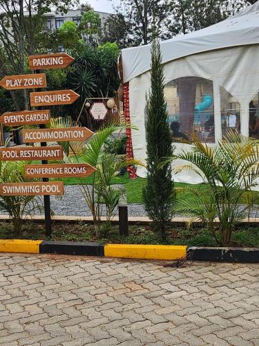 a bunch of signs in front of a building at Kivulini Eco Park Karen in Nairobi