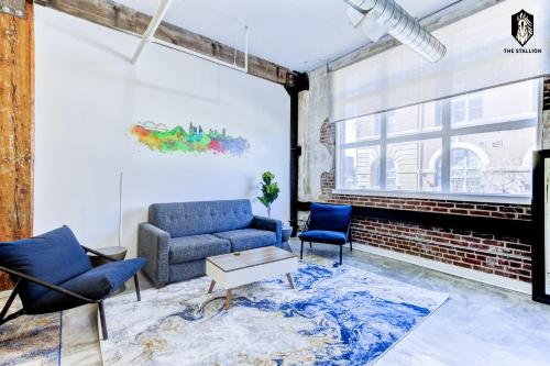 a living room with a couch and two chairs at The Stallion #106 - Walk to Museums, Luxe Loft with free gated parking in Memphis