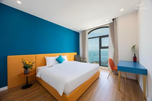 a bedroom with a large bed and a blue wall at Luna Sol Villas - Dedicated Care Until Check Out in Phu Quoc