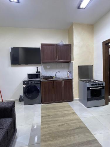 an empty kitchen with a stove and a sink at Osama Alnaser in Amman
