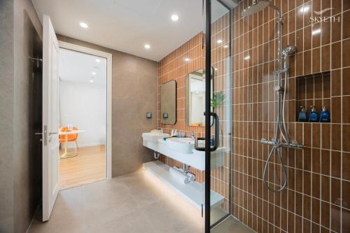 a bathroom with a shower and a sink at Luna Sol Villas - Dedicated Care Until Check Out in Phu Quoc