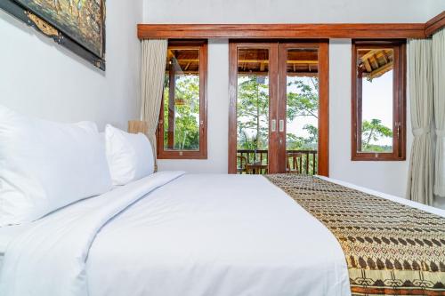 Postel nebo postele na pokoji v ubytování Villa Kuma Ubud
