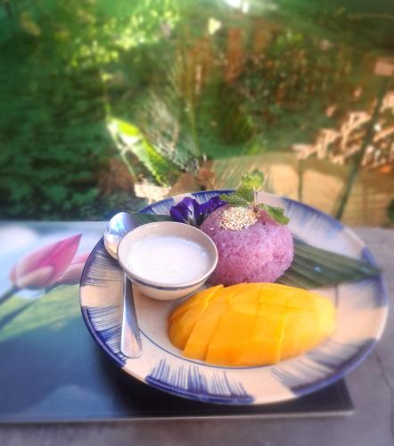 a plate of food with fruit on a table at GOLDEN LOTUS SPA & HOMESTAY in Ấp Thiện Phước