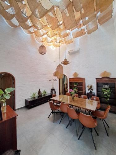 a dining room with a wooden table and chairs at GOLDEN LOTUS SPA & HOMESTAY in Ấp Thiện Phước