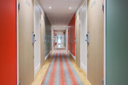 a long hallway with a colorful rug on the floor at Good Morning Örebro in Örebro