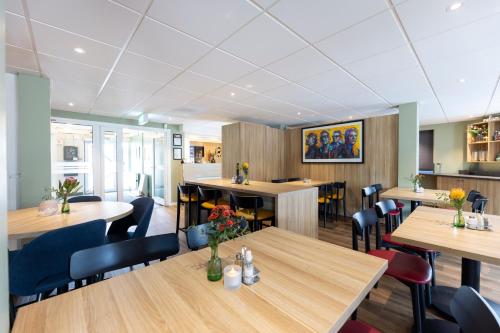 a dining room with wooden tables and chairs at Good Morning Örebro in Örebro