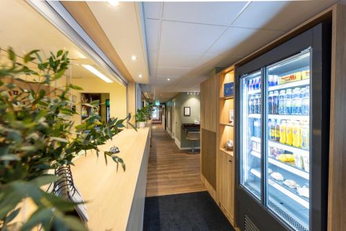 an office cafeteria with a refrigerator filled with drinks at Good Morning Örebro in Örebro