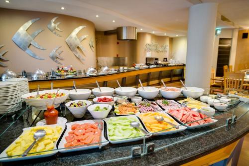 a buffet line with many different types of food at Protea Hotel by Marriott Knysna Quays in Knysna