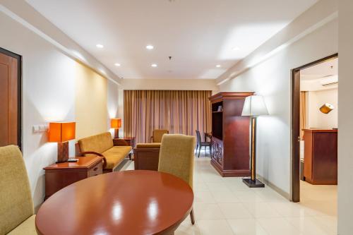 a room with a table and chairs and a living room at Bintang Flores Hotel in Labuan Bajo