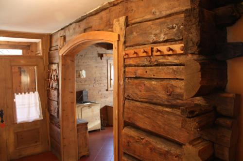 a wooden door in a room with a stone wall at Chalet Renzo in Livigno