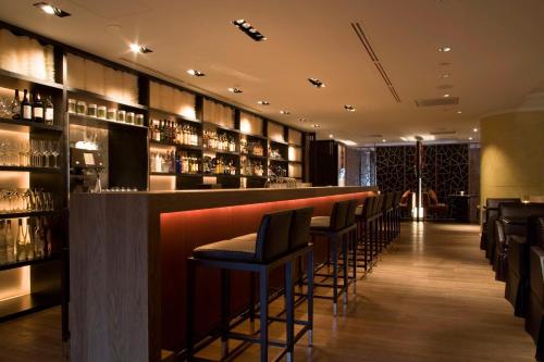 a bar with a row of bar stools at Grand Hyatt Taipei in Taipei