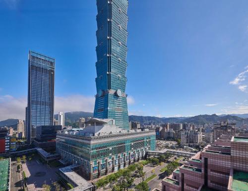 a tall skyscraper in the middle of a city at Grand Hyatt Taipei in Taipei