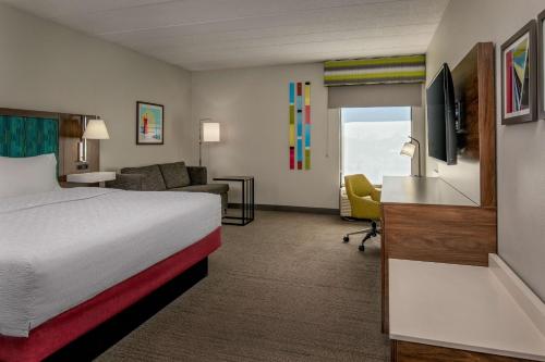 a hotel room with a bed and a living room at Hampton Inn Rehoboth Beach in Rehoboth Beach