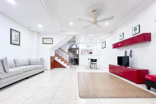 a living room with a couch and a tv at Homestay Taman U12, Shah Alam - Smarthome in Shah Alam