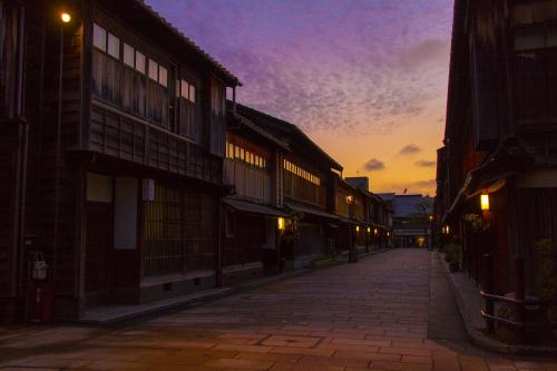 an empty street with a sunset in the background at Tokyu Stay Kanazawa in Kanazawa