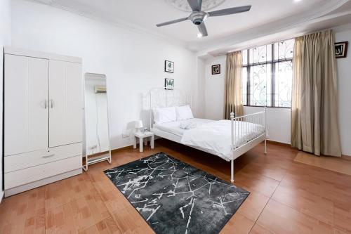a white bedroom with a bed and a window at Homestay Taman U12, Shah Alam - Smarthome in Shah Alam