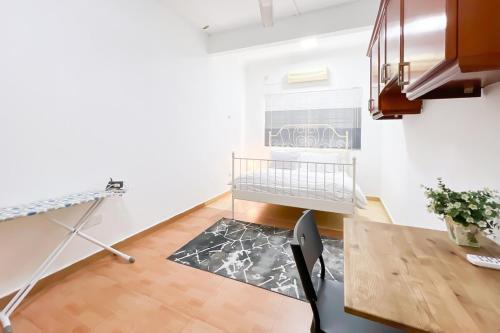 a living room with a table and a crib in it at Homestay Taman U12, Shah Alam - Smarthome in Shah Alam
