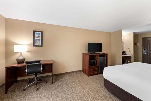 a hotel room with a bed and a desk with a computer at Comfort Inn & Suites El Centro I-8 in El Centro