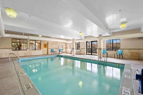 a large swimming pool in a hotel room at AmericInn by Wyndham Denver Airport in Denver