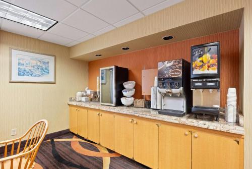 a bar in a room with a counter with appliances at AmericInn by Wyndham Denver Airport in Denver