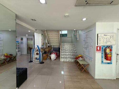 a hallway with a staircase in a building at Bed By Boat @Nonthaburi Pier in Nonthaburi