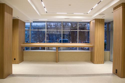 an office lobby with a large window and a desk at Resident Hotel Abay in Almaty