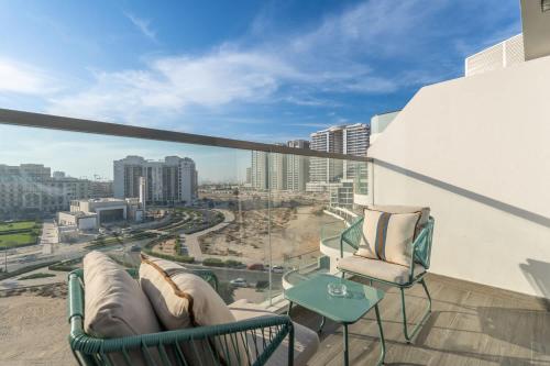 a balcony with chairs and a view of a city at Free housekeeping visits during your stay - StayShort - Delightful Studio in Park Views that Sleeps 2 in Dubai
