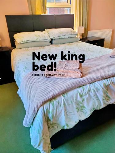 a bedroom with a bed with a new king bed at Family Home Near City Centre in Carlisle