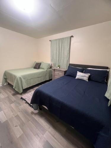 a bedroom with two beds and a window at Simplicity Stays NOLA 2 in New Orleans