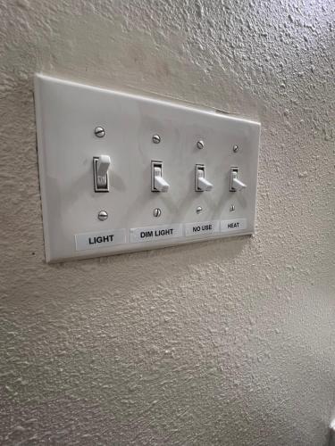 a lightswitch on the wall of a room at Simplicity Stays NOLA 2 in New Orleans