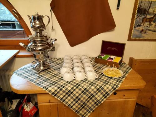 a table with a tea pot and candles on it at Hotel Dal Bracconiere in Folgarida