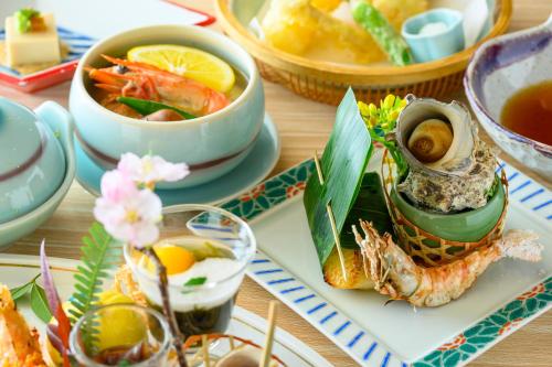 a table with bowls of soup and a plate of food at 岩井温泉　岩井屋 in Iwamicho
