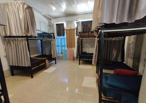 a room with several bunk beds in a room at Via Hostel Pakse in Pakse