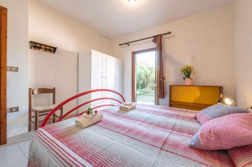 a bedroom with a bed with two towels on it at Apartment in San Teodoro 23144 in San Teodoro